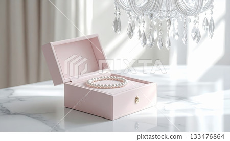 White Crystal Table Lamp with Jewelry Box and Pearl Necklace on White Marble Table 133476864