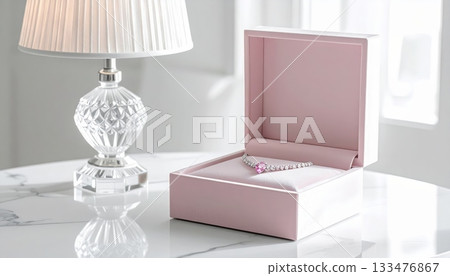 White Crystal Table Lamp with Jewelry Box and Diamond Necklace on White Marble Table 133476867