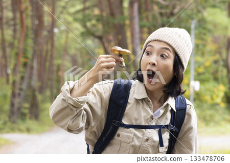 Woman hunting mushrooms 133478706