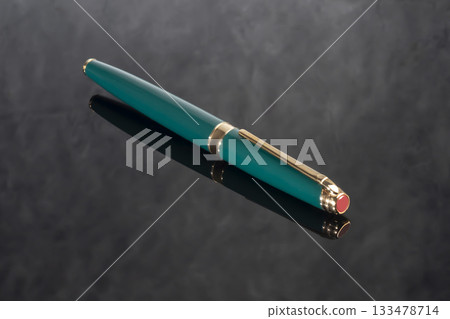 A branded fountain pen next to a box. Gift set. Selective focus. Office interior A branded fountain pen next to a box. Gift set. Selective focus. Office interior 133478714