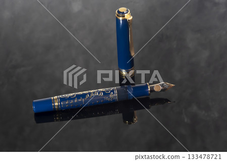 A branded fountain pen next to a box. Gift set. Selective focus. Office interior 133478721