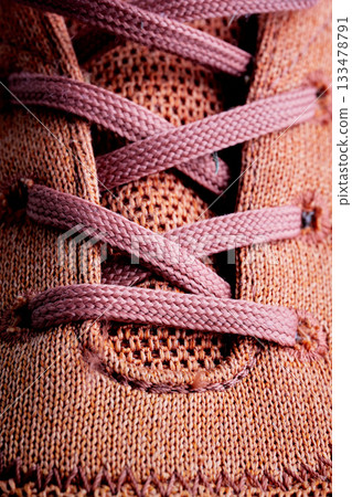 Shoelaces on a stylish sneaker, showcasing textile details. Shoelaces on a stylish sneaker, showcasing textile details. 133478791