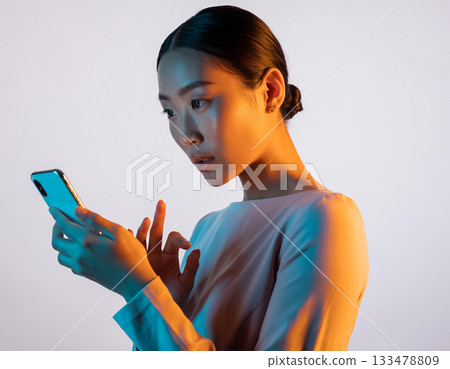 A woman watching a smartphone 133478809