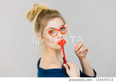 woman holds carnival accessories on stick woman holds carnival accessories on stick 133479713