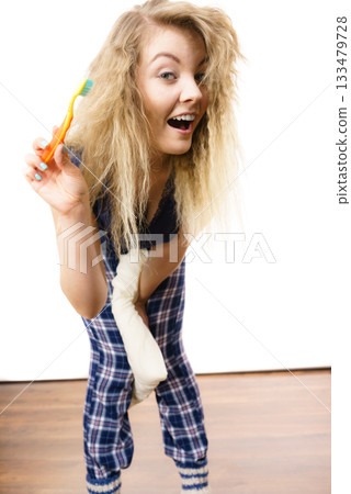 Happy woman brushing her teeth Happy woman brushing her teeth 133479728