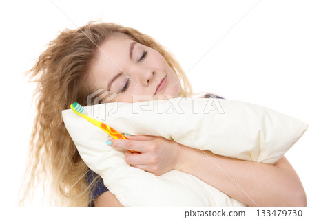 Sleepy woman hugging white pillow Sleepy woman hugging white pillow 133479730