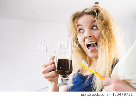 Funny woman being late drinking coffee 133479731