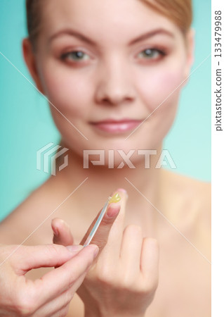 woman applying balsam for lips 133479988