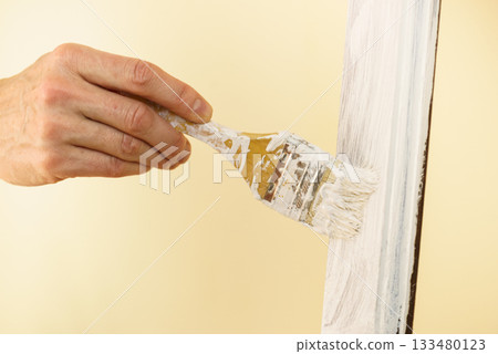 Person renovating wooden hanger 133480123