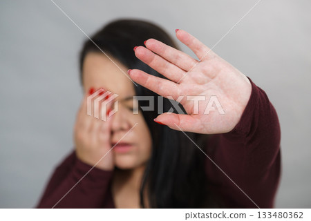 Scared woman with stop hand gesture 133480362
