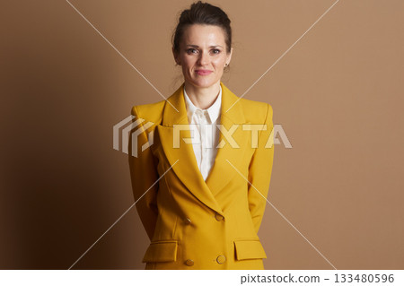 Confident Businesswoman in Yellow Blazer 133480596