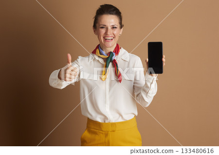 Professional Woman Approves Smartphone with Thumbs-Up Professional Woman Approves Smartphone with Thumbs-Up 133480616