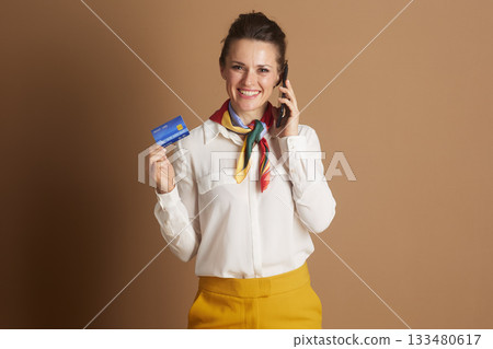 Woman Multitasking: Phone Call and Credit Card Woman Multitasking: Phone Call and Credit Card 133480617