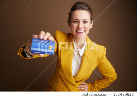 Woman in Yellow Suit Presenting Credit Card 133480626