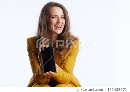 Smiling Businesswoman Showcasing Smartphone 133482071