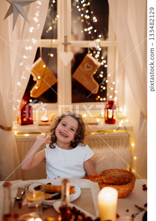 Cheerful small girl during Christmas Eve. Banner with copy space. 133482129