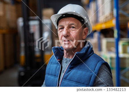 Portrait of mature warehouse worker with helmet. Portrait of mature warehouse worker with helmet. 133482213