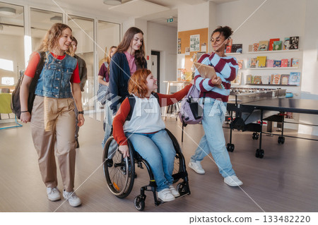 Teen students in school hallway, girl in wheelchair. 133482220