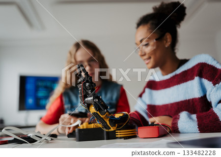 High school students working on robotics project, using online AI app to answer questions. High school students working on robotics project, using online AI app to answer questions. 133482228