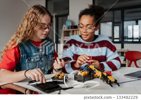 High school students working on robotics project, using online AI app to answer questions. High school students working on robotics project, using online AI app to answer questions. 133482229