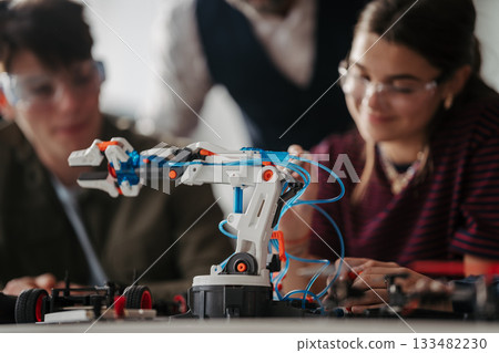 High school students working on robotics project. High schoolers in STEM. High school students working on robotics project. High schoolers in STEM. 133482230