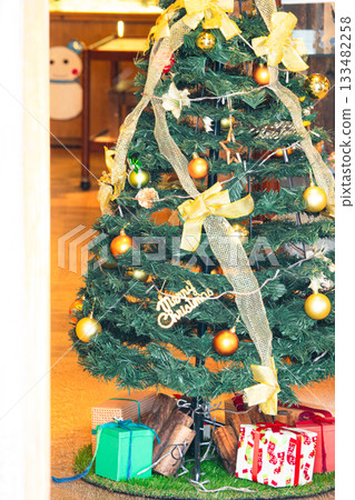 A Christmas tree seen through a store window from the street A Christmas tree seen through a store window from the street 133482258