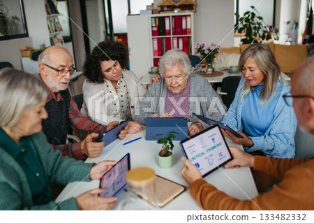 Group of senior people learning digital skills with tutor help. Group of senior people learning digital skills with tutor help. 133482332