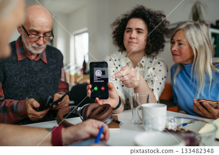 Tutor teaching seniors about phone scams and digital safety. 133482348