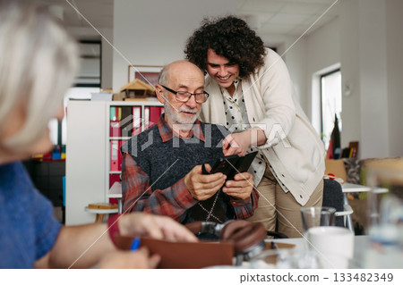 Tutor teaching seniors about phone scams and digital safety. 133482349
