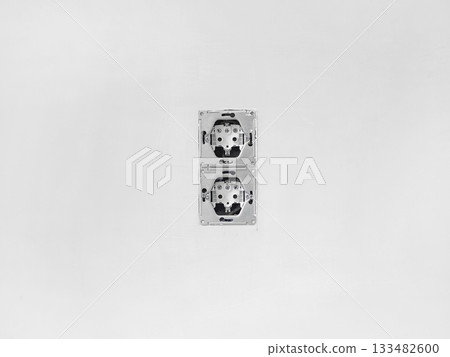 vertical socket box is installed on a concrete wall vertical socket box is installed on a concrete wall 133482600