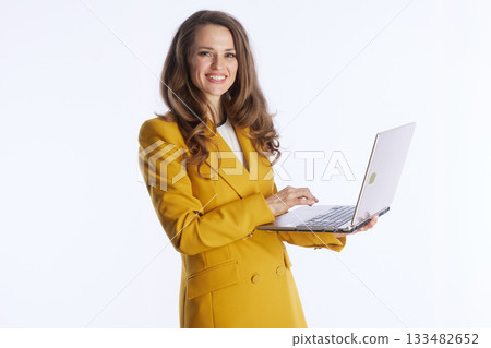 Confident Businesswoman Typing on Silver Laptop Confident Businesswoman Typing on Silver Laptop 133482652