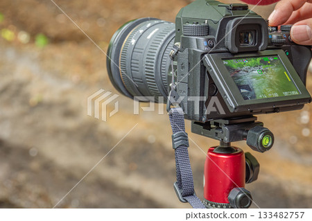 Landscape photography using a camera set on a tripod at a mountain stream in Minamimaki Village, Nagano Prefecture Landscape photography using a camera set on a tripod at a mountain stream in Minamimaki Village, Nagano Prefecture 133482757