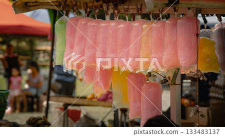 Vibrant colored cotton candy bags hang from a food stand at the weekend market in Valencia, Negros Oriental, Philippines Vibrant colored cotton candy bags hang from a food stand at the weekend market in Valencia, Negros Oriental, Philippines 133483137