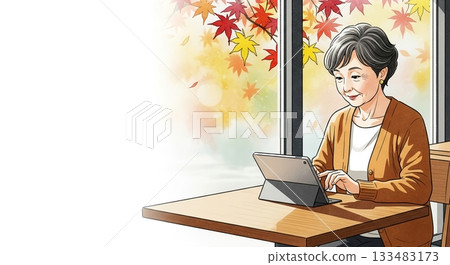 Senior woman enjoying the autumn sunshine with a tablet 133483173