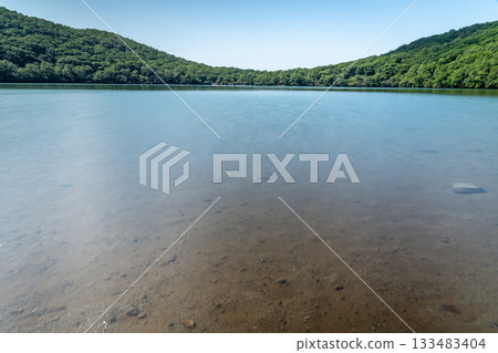 Lake Konuma on Mount Akagi in Gunma Prefecture, with a blue summer sky and a magnificent view of water and forest Lake Konuma on Mount Akagi in Gunma Prefecture, with a blue summer sky and a magnificent view of water and forest 133483404