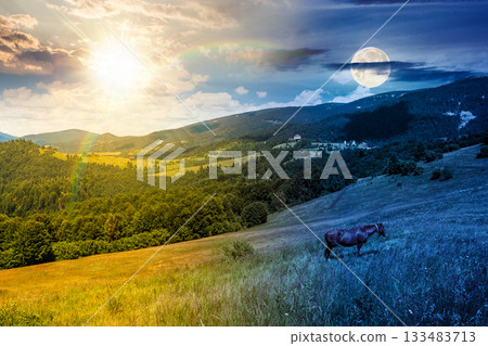 horse grazing on lush green field. day and night time change concept. serene rural landscape with sun and moon at twilight. alpine scenery during autumn. sustainability duality and transition template 133483713