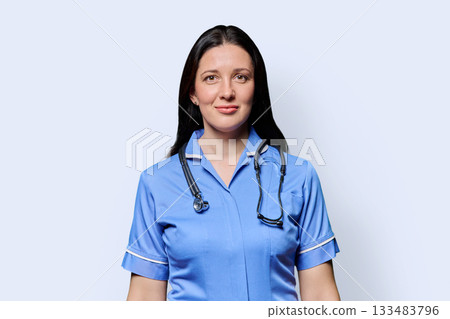 Portrait of middle-aged woman doctor, nurse on light studio background Portrait of middle-aged woman doctor, nurse on light studio background 133483796