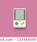 a retro handheld game console on pink 133484099