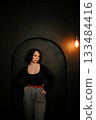 Thoughtful Woman Posing in Stylish Outfit with Lighting 133484416