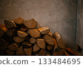 Stack of Firewood Against Rustic Wall 133484695