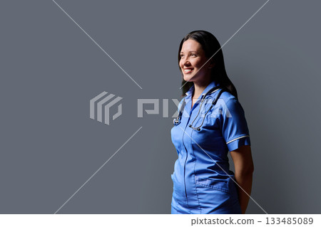 Profile portrait of middle-aged woman doctor, nurse on grey studio background Profile portrait of middle-aged woman doctor, nurse on grey studio background 133485089