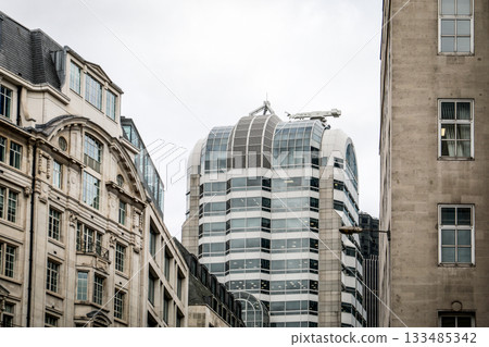Modern Office Tower Surrounded by Historic City Buildings Modern Office Tower Surrounded by Historic City Buildings 133485342