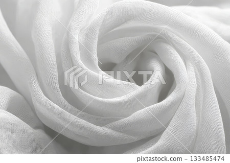 Elegant Close-Up of Luxurious White Silk Fabric with Beautiful Swirl Patterns in Soft Light Setting 133485474