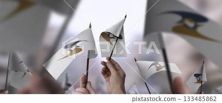 Eurasian Economic Union flags in their hands on a blurred urban background 133485862