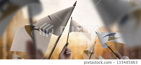 Eurasian Economic Union flags in their hands on a blurred urban background 133485863