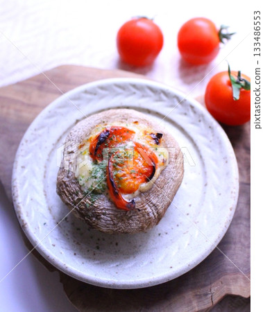 A dish of shiitake mushrooms stuffed with tomato and baked 133486553