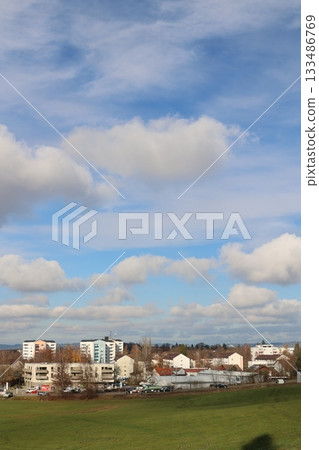 Urban Landscape with Green Field and Blue Sky 133486769