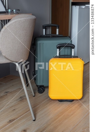 Luggage standing in hotel room ready for travel Luggage standing in hotel room ready for travel 133486874