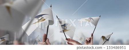 Eurasian Economic Union flags in their hands on a blurred urban background Eurasian Economic Union flags in their hands on a blurred urban background 133486951