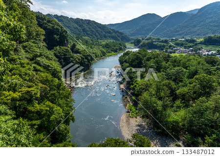 Summer valley of the Tone River in Gunma Prefecture, majestic mountains, clear streams and villages 133487012